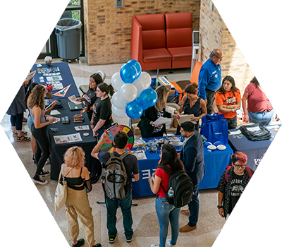 Student event indoor with tables and students and games to play