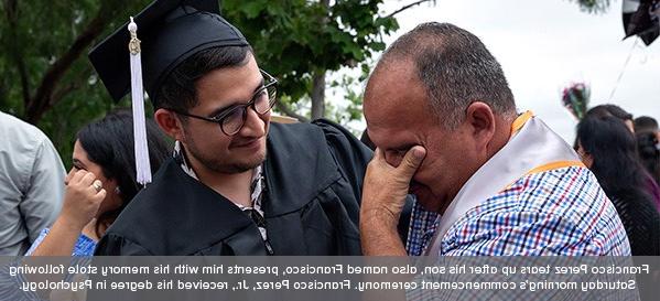 Francisco Perez tears up after his son, also named Francisco, presents him with his memory stole following Saturday morning's commencement ceremony. Francisco Perez, Jr. received his degree in Psychology.